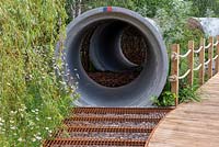 Concrete drainage pipes used as a tunnel - The Thames Water Flourishing Future Garden, RHS Hampton Court Palace Flower Festival 2019.