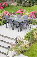 Patio with dining furniture in modern suburban garden