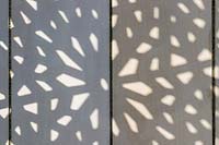 Shade pattern on paving from decorative screens.