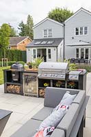 Paved area with built in outdoor kitchen, cooking area and lounge furniture