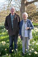 Couple standing amongst naturalised Narcissus - Daffodil