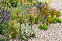 RHS Hampton Court Palace Garden Festival 2019. Planting combination for a dry gravel garden includes Stipa tenuissima, Ballota pseudodictamnus, Allium cristophii, Nepeta, Verbena rigida, Libertia peregrinans.