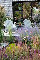Relaxing area on patio and perennial flower border