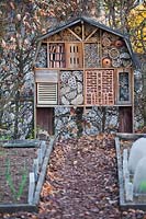 Insect house on wooden supports in a vegetable garden