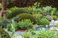Peaceful pool area with porcelain stepping stones and colourful planting in the Morgan Stanley Garden at RHS Chelsea Flower Show 2019