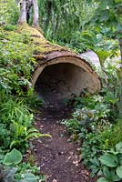 Hollow tree trunk for children to hide in - The RHS Back to Nature Garden, RHS Chelsea Flower Show 2019.