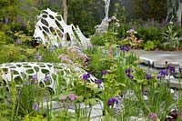 The Manchester Garden, view of the garden and its ondulating white sculptures, with planting including Iris sibirica 'Caesar's Brother', Iris sibirica 'Persimmon', Valerian and Rodgersia. Sponsors: Aviva Investors and Cole Waterhouse.
