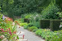 Hedge dividers and path with flowerbeds 