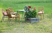 Field with rough cut area of grass for a table and chairs