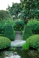 Clipped topiary in formal garden, with classic pond. 