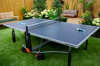 West London garden with table tennis table on artificial lawn.