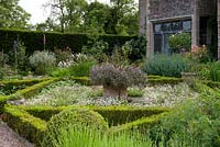 Parterre garden near house, beds filled with flowers