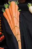 Exhibition Carrot 'Red Intermediate' - bunch tied and presented on black cloth