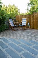 Deck chairs  and a small table on wooden decking