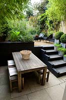 View from dining area with steps up to a multi-level urban garden