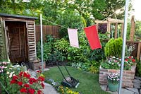 Shed, crazy paving, lawnmower, and washing line in the 1960's Anniversary Garden at BBC Gardener's Live 2017.