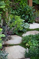 Hexagonal paving lined with heuchera, alchemilla mollis and brunnera in the 1970's Anniversary Garden at BBC Gardener's World Live 2017.