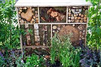 Tiered insect hotels made from recycled materials in the 'Living in Sync' garden at BBC Gardener's World Live 2017