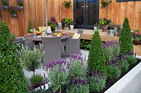 Contemporary outdoor living and dining space in the Tesco 'Every Little Helps' garden at BBC Gardener's World Live 2017