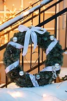 Winter decorations - white themed wreath with ribbons and baubles