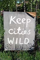 Keep Cities Wild sign at Dalston Eastern Curve Garden, an urban community garden in the London Borough of Hackney.