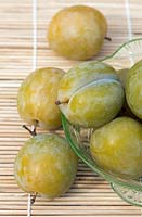 Prunus insititia - Greengage Reine Claude de Bavay, greengages in vintage glass bowl.