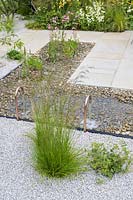 Rectangular water feature surrounded by aggregate and paving surface - The Urban Pollinator Garden - RHS Hampton Court Palace Garden Festival, 2019.