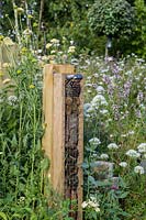Bug hotels surrounded by flowering perennials - The BBC Spring Watch Garden - RHS Hampton Court Festival - Design: Jo Thompson in consultation with Kate Bradbury