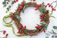 Wicker wreath with rosehips, pine cones and Eucalyptus foliage.