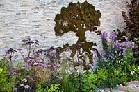 Decorative moss in shape of a tree on the stone wall in the 'Wetland Plants - The idea of Wilderness' garden 