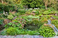Sunken garden with mixed beds and small pond