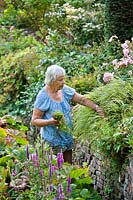 Dutch garden designer Els de Boer working in her garden.