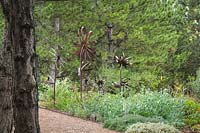 Pinus nigra - Handcrafted metal flowers under Austrian Pines.