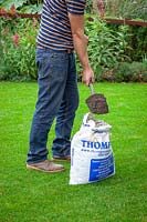 Top dressing a lawn with soil