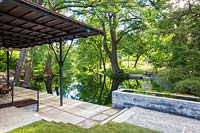 View to pool from paved verandah at Mill Creek Ranch in Vanderpool, Texas designed by Ten Eyck Landscape Inc, July.