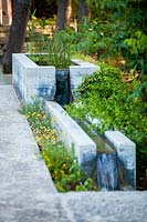 Concrete spring water fountain, Mill Creek ranch in Vanderpool, Texas, USA designed by Ten Eyck Landscape Architects, July.