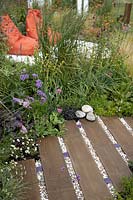 'Find Yourself Lost in the Moment' garden - RHS Chatsworth Flower Show 2019 - view of path showing mixed materials.