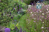 'RHS Garden for Wildlife Wild Woven' - RHS Chatsworth Flower Show 2019 - winding grass path through wildflower borders.