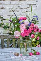 Mixed summer flower arrangement in glass jar with Roses, Ammi major, Veronica, Mint and Scabious
