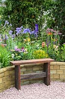 Simple wooden bench in front of raised bed with flowerbed -The Therapeutic Garden - RHS Hampton Court  Palace Garden Festival 2019  - Sponsor: Southend-on-Sea Council, Wood BlocX FormaraPrint 