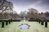 View to Pavilion and lake, across clipped fastigiate Yew flanking the fountain pool and lawn at Littlethorpe Manor, Yorkshire, UK. Designed by Eddie Harland.