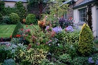 Mixed border with shrubs and perennials in Autumn  