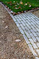 Detail of gravel driveway, brick path and Lawn.