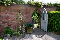 Secret door leading from the courtyard garden at Wollerton Old Hall Garden, Shropshire.