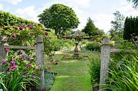 View through Alice's Garden to The Sundial Garden and Llanhydrock Garden beyond at Wollerton Old Hall Garden, Shropshire.