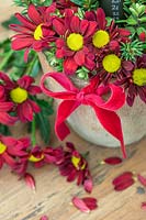 Floral arrangement with red Chrysanthemums and velvet bow