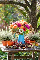 Bouquet of autumn flowers in jug including Dahlias, Zinnia, Hydrangea, Heather.