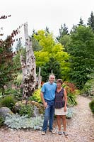 Couple standing together in their rural garden