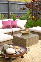 Outdoor rattan furniture can be used year-round especially with a fire bowl to keep warm.