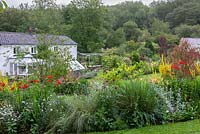 Set in a peaceful Welsh valley, the 1840s cottage glimpsed over island beds planted with verbascums, monardas, crocosmias, echiums, daylilies, diascias and ornamental grasses.